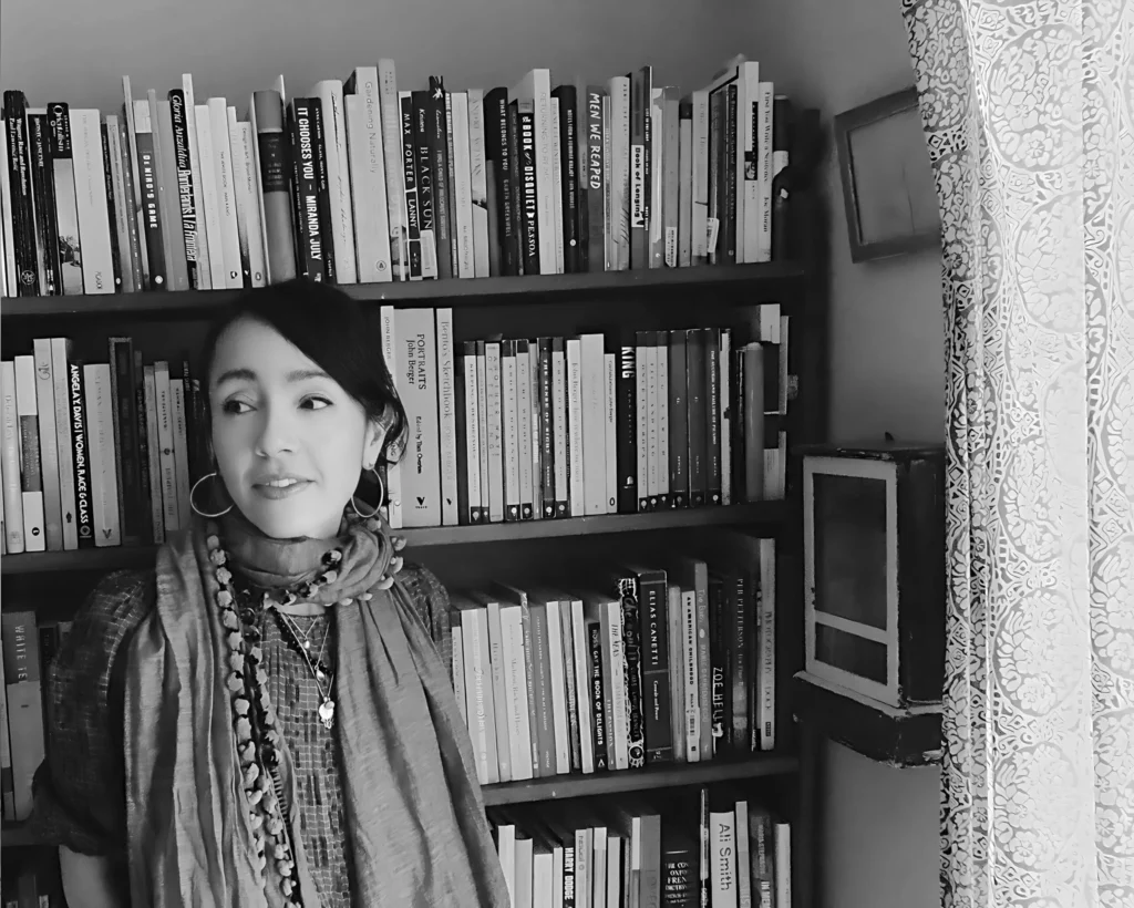 Kyo Maclear standing in front of a bookshelf Photo by David Wall
